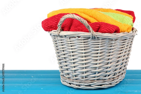 Fototapeta Colorful towels in basket on light background