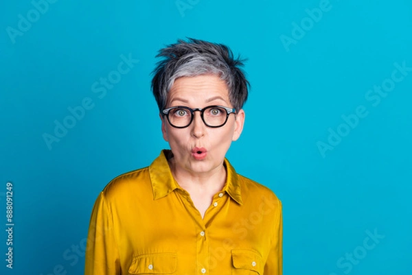 Fototapeta Photo of impressed cheerful woman wear blouse spectacles emtpy space isolated blue color background