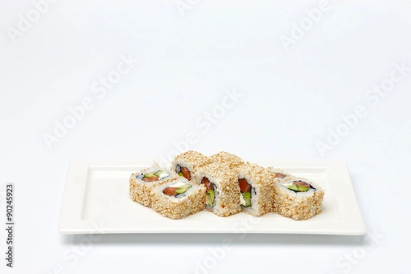 Fototapeta Pieces of sushi on white ceramic plate.