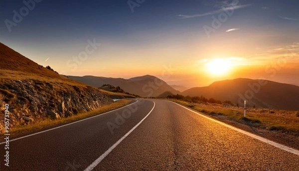 Fototapeta sunset on empty mountain road symbolic of journey s end or new beginnings