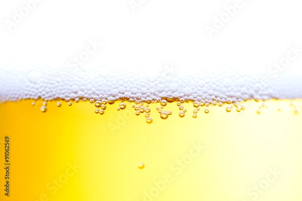 Fototapeta Bubbles of beer froth in glass