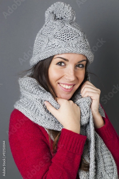 Fototapeta happy female teenager smiling in holding her warm winter scarf