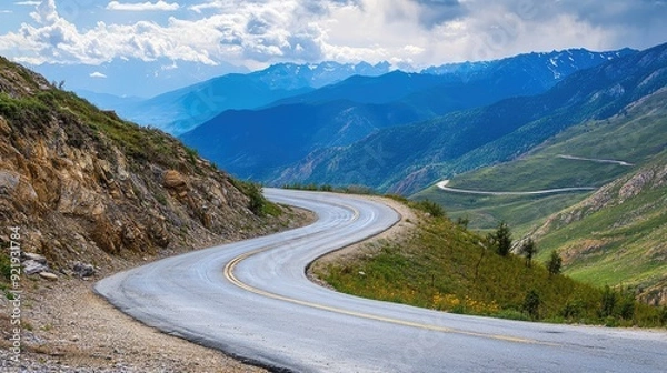 Fototapeta Scenic mountain road with dramatic turns and expansive views of distant peaks. Great for outdoor adventure and travel imagery