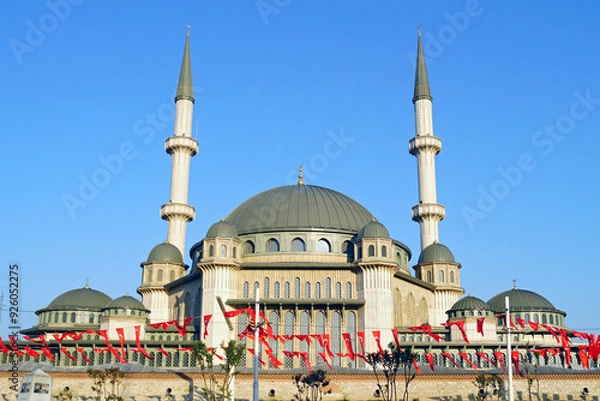 Fototapeta Exterior of the Taksim Mosque in Istanbul. The domes and minarets of the mosque built on Istanbul's famous Taksim Square are photographed against a blue sky. Modern Islamic architecture in Turkey.