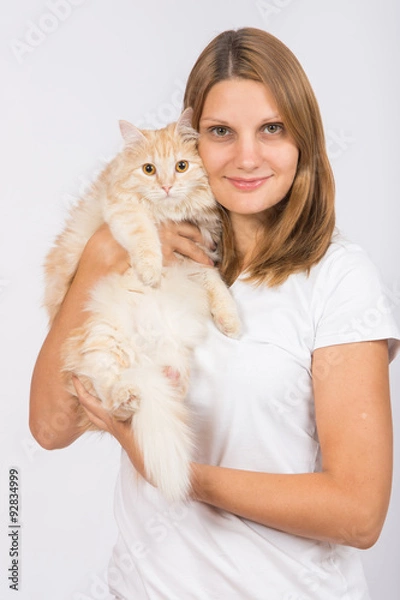 Fototapeta Girl hugging domestic cat