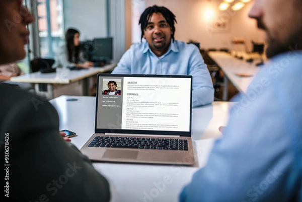 Fototapeta Recruiters looking at candidates cv on a laptop. African American businessman having job interview in the office.