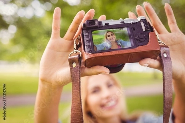 Fototapeta Smiling woman taking self portrait 