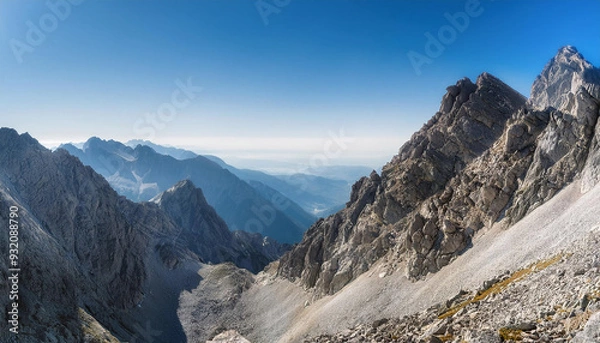 Fototapeta Panoramic View of Rugged Mountain Range with Blue Sky