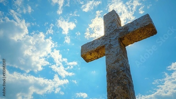 Fototapeta Wooden cross stands on grass in field,copy space,banner,symbolizing Jesus' death and resurrection.