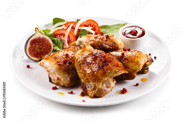 Fototapeta Roasted chicken drumsticks and vegetables