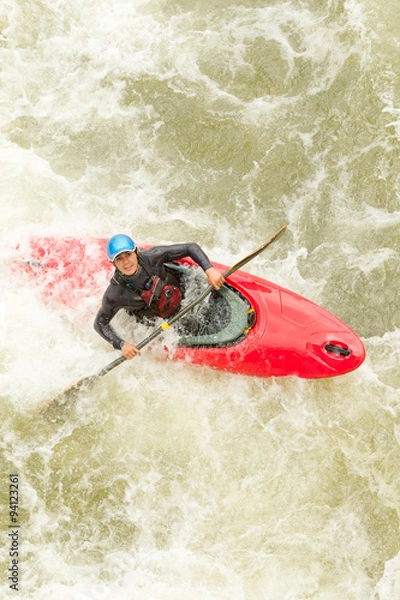 Fototapeta Experienced kayaker navigating challenging whitewater rapids with skill and precision.