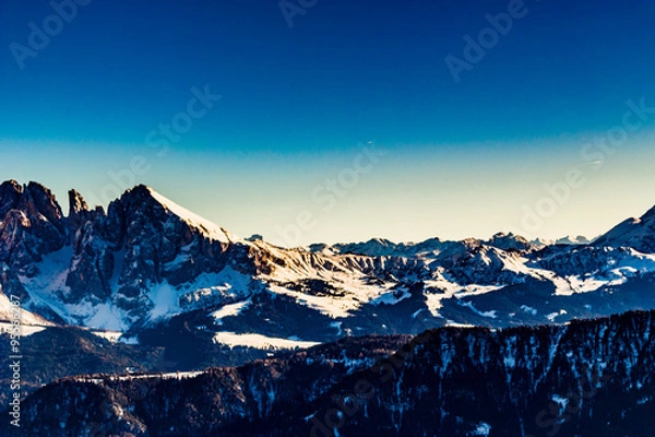 Fototapeta panorama of the Dolomites with snow-capped peaks and conifers