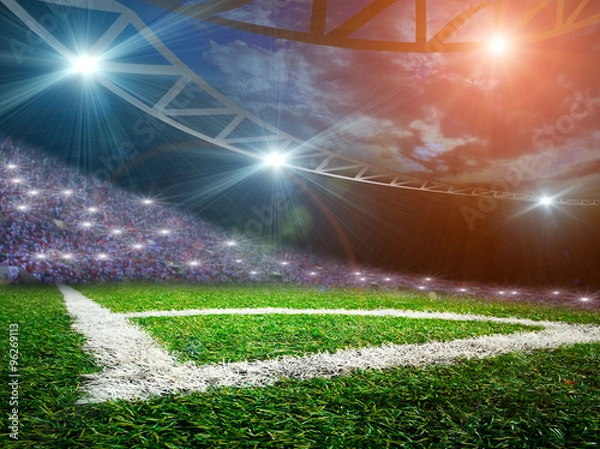 Fototapeta Soccer ball on green stadium, arena in night illuminated