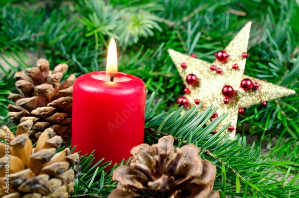 Fototapeta Christmas decoration with pine cones and red candle