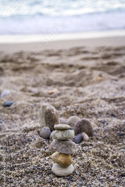 Fototapeta Little stones stack on beach. Color image