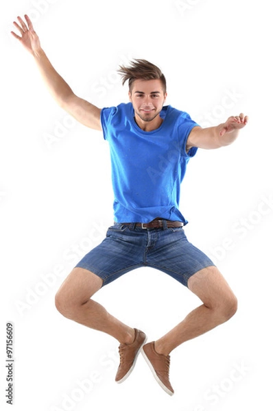 Fototapeta Active guy jumping in joy, isolated on white