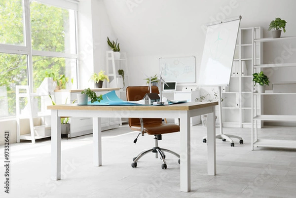 Fototapeta Interior of engineer's office with workplace and wind turbine models