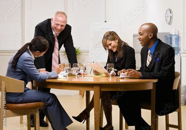 Fototapeta Co-workers having financial meeting in conference room