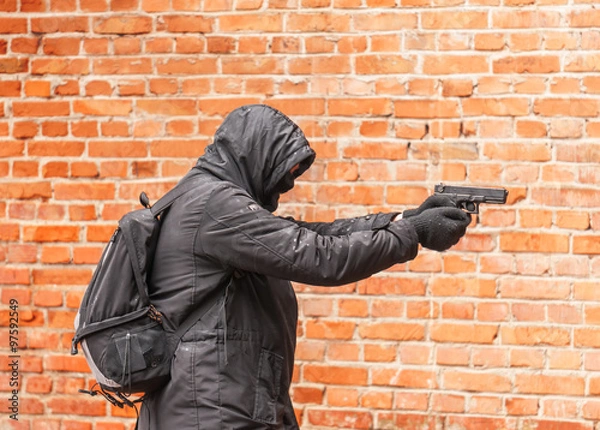 Fototapeta man in black with gun