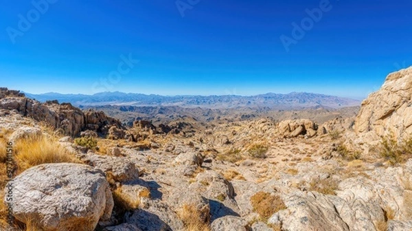 Fototapeta Mountainous Landscape with Blue Sky and Rugged Terrain