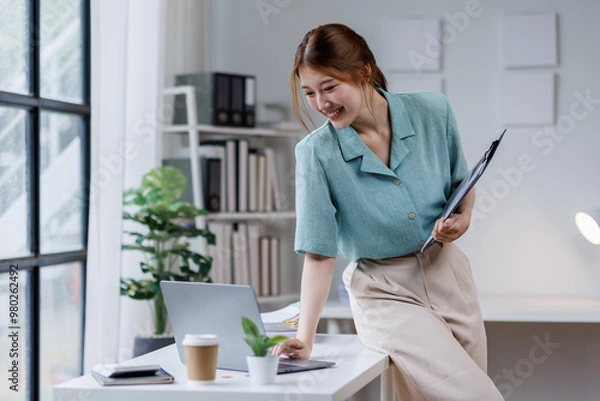 Fototapeta Generation young girl or business asian woman with clipboard in eorkplace office.education and business concept.