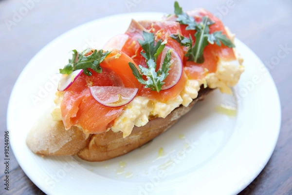 Fototapeta Scrambled eggs with smoked salmon and whole wheat toast