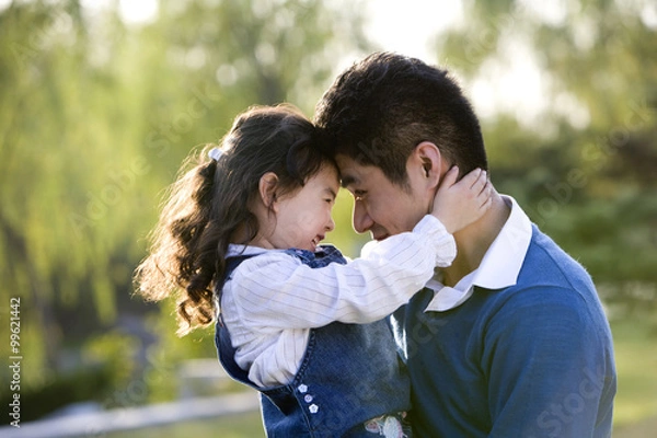 Fototapeta Portrait of father and daughter at the park